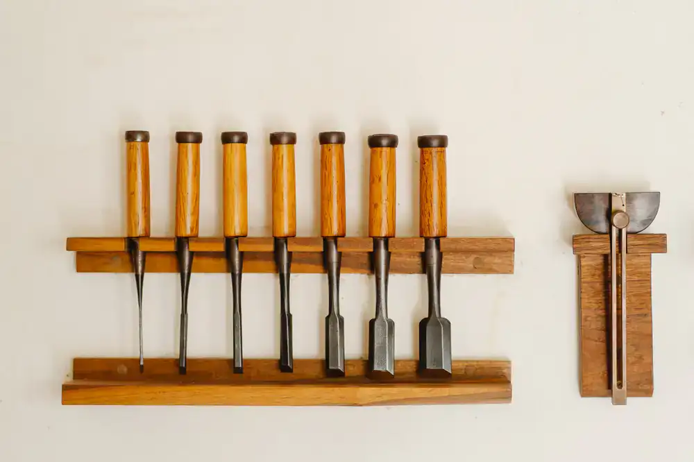 A view of the artisan's tools organized on a wall rack
