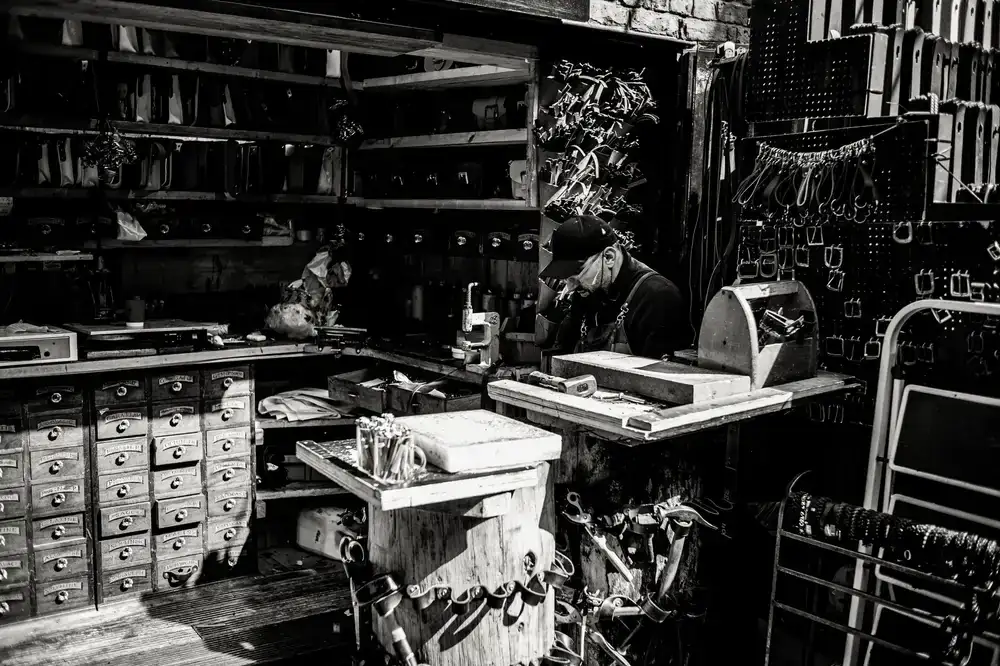 Leather artisan working at a wooden bench